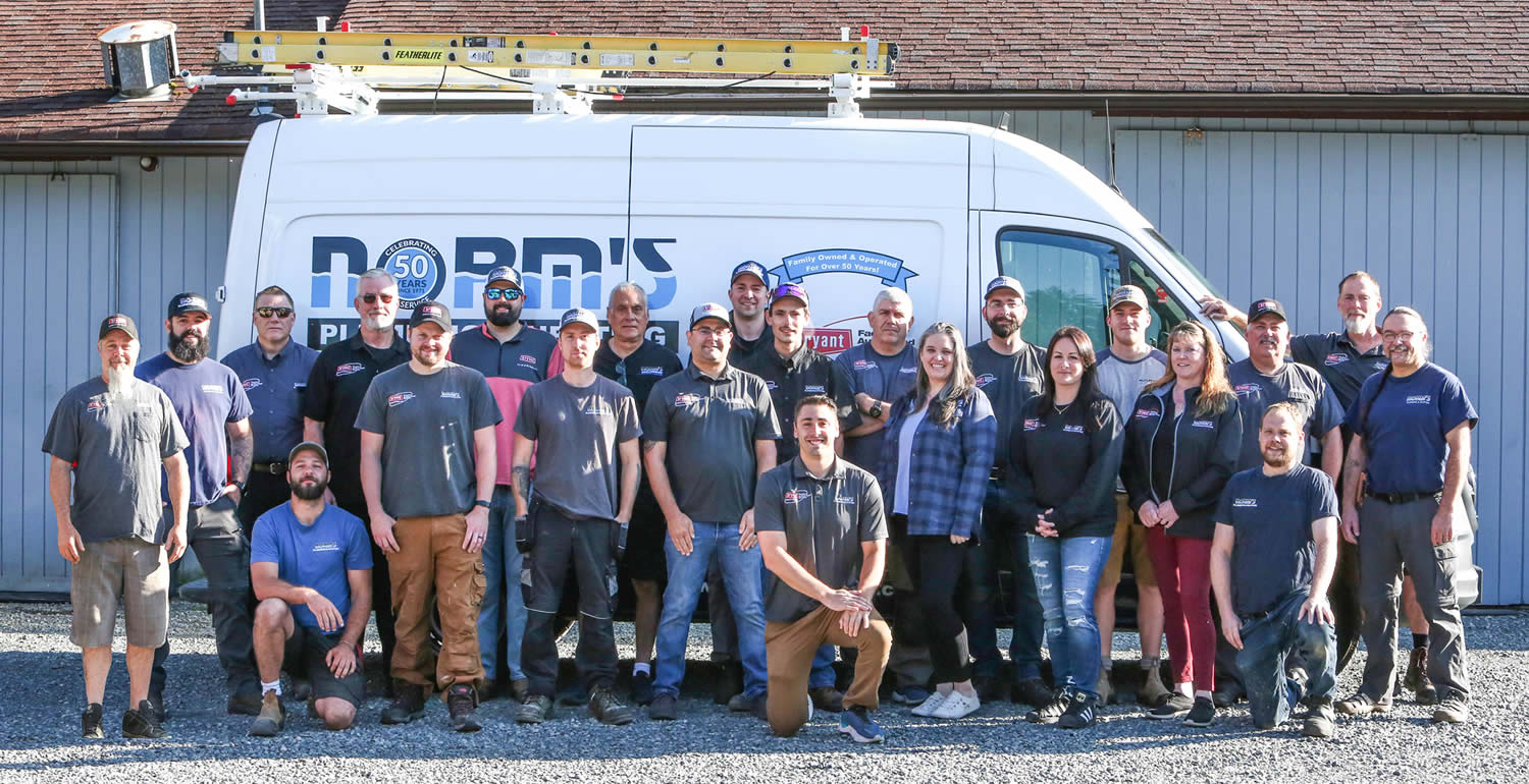 Company picture in front of Norm’s Plumbing van