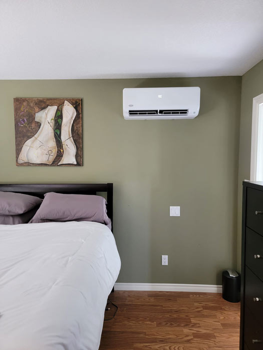 ductless heat pump on a bedroom wall