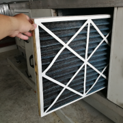 furnace filter Dirty furnace filter being removed during a change furnace filter walkthrough