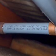 2 Close-up of grey Poly-B plumbing pipes with metal crimp fittings between floor joists.