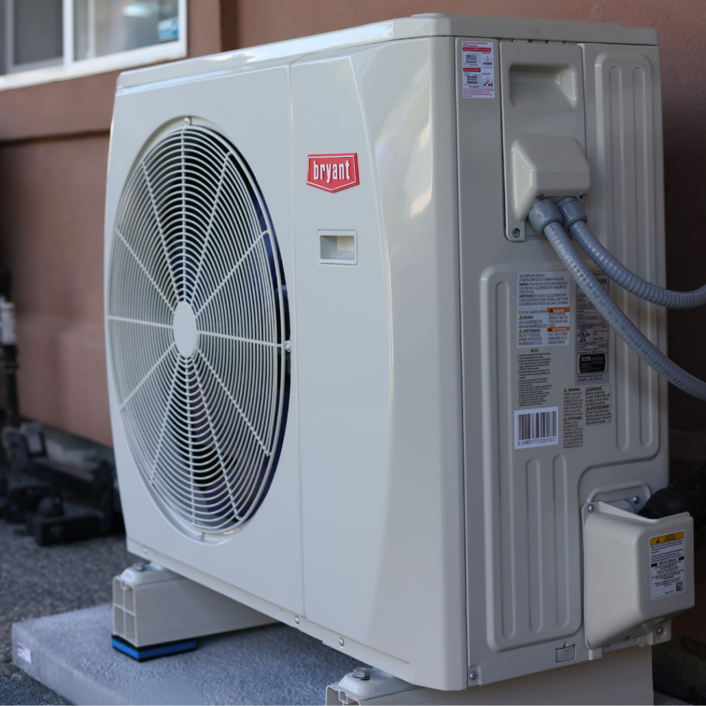 How Do I Choose the Best Heat Pump to Buy? 2 Close-up of a Bryant heat pump outdoor unit showing the fan grille and service connections.